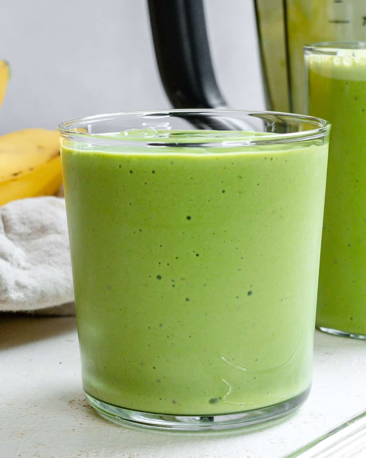 ready-made banana and kale smoothie in two glasses