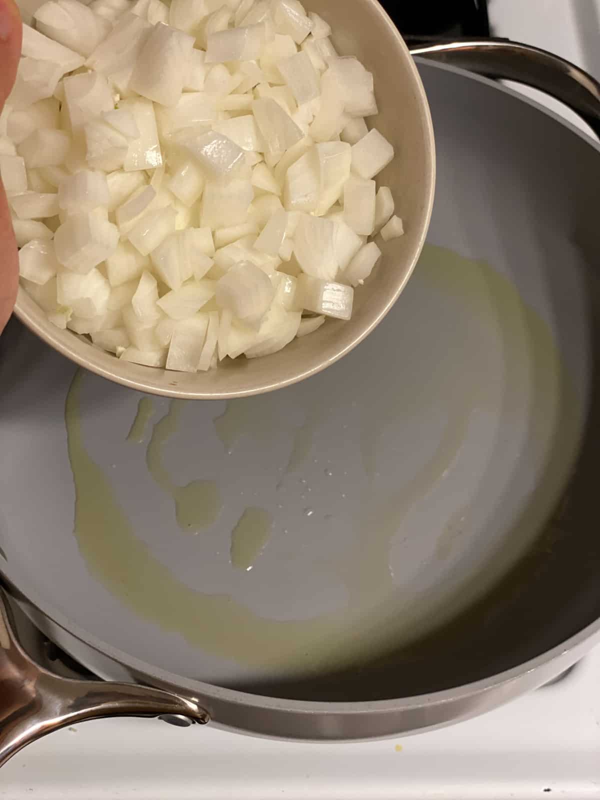 Diced onion cooking in a skillet for vegan mushroom gravy.