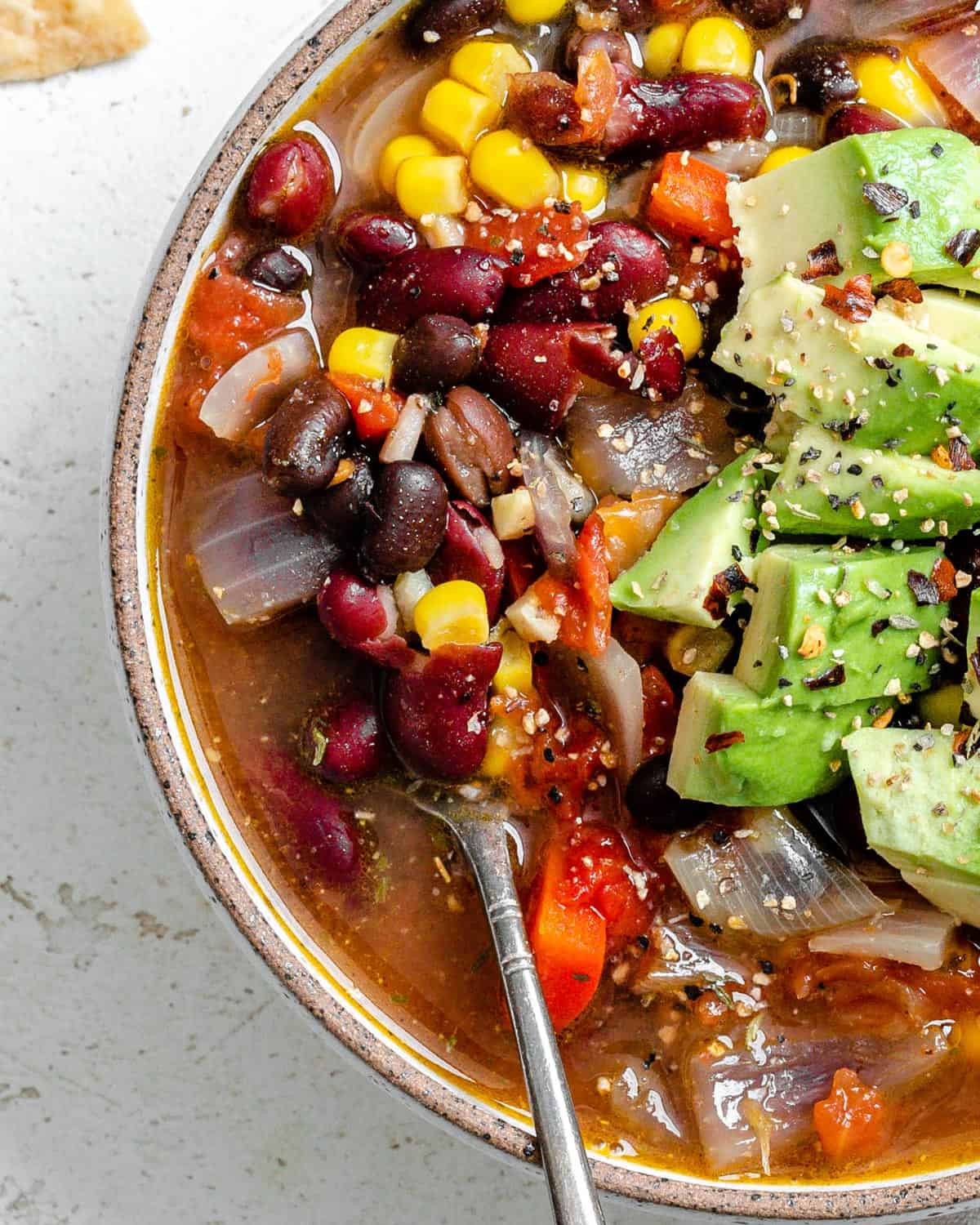 completed Quick Mexican Bean Soup [Stove + Crockpot] in a bowl against a light background