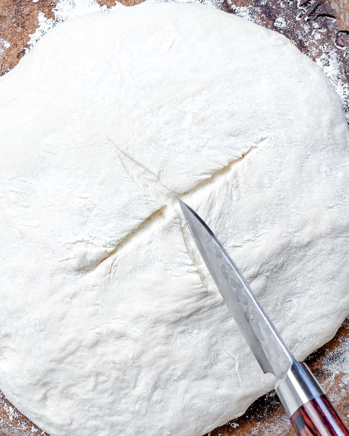 process shot of cutting a small slit onto top of dough