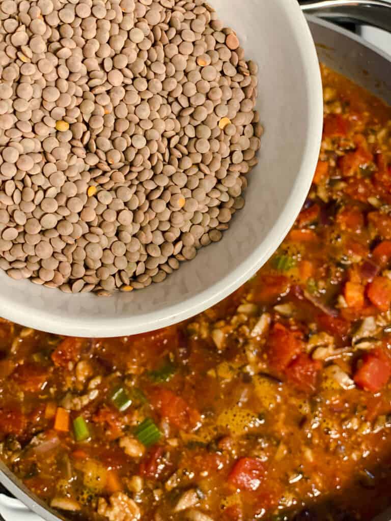 process shot of adding lentils to pan