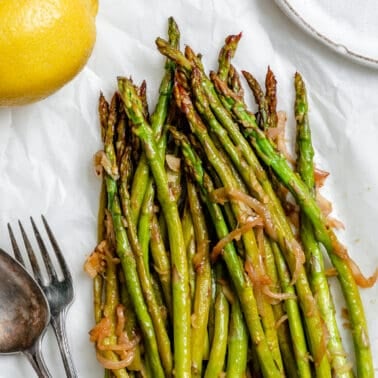 completed Sauteed Asparagus with Lemon and Garlic against a white background
