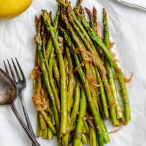 completed Sauteed Asparagus with Lemon and Garlic against a white background