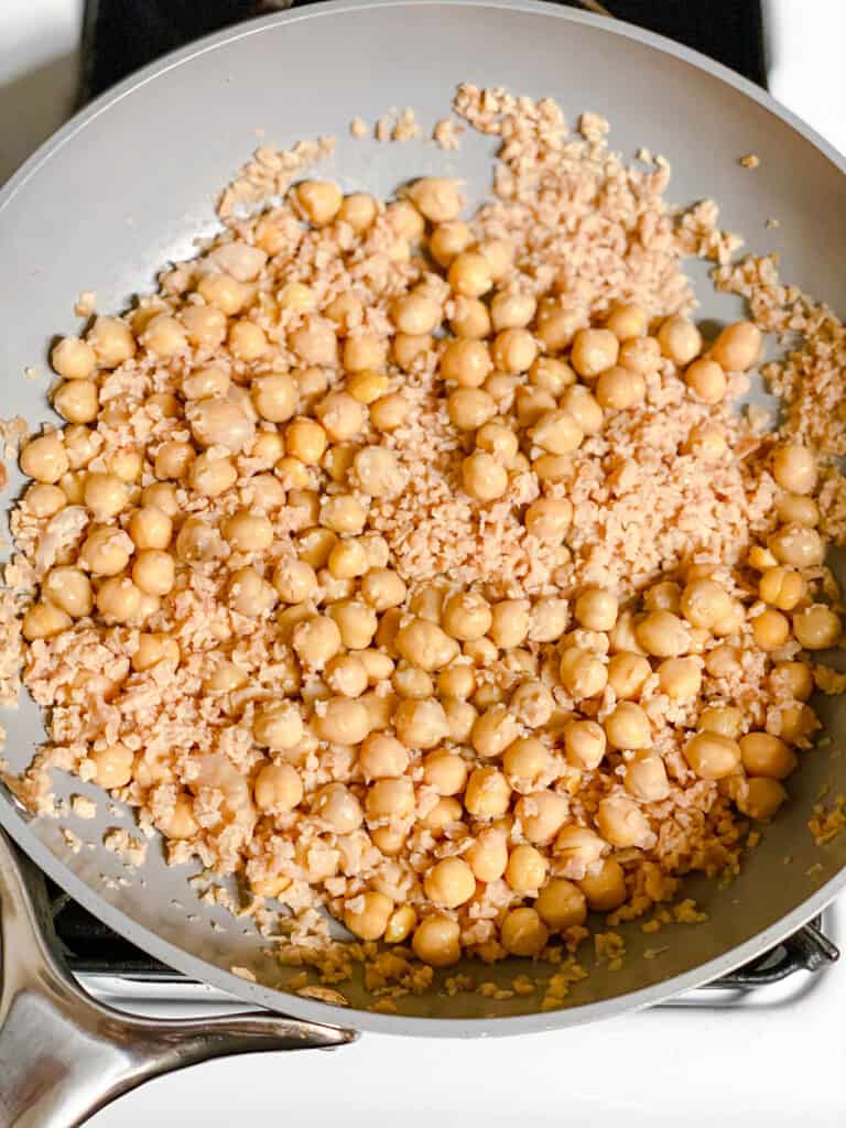 process shot of chickpeas and TVP being cooked in pan