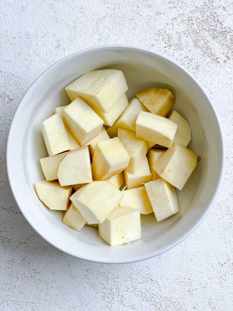 cubed potatoes in a white bowl