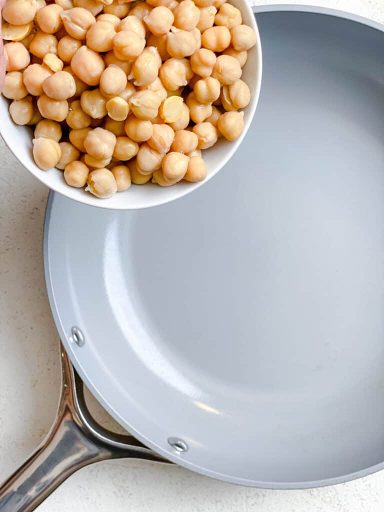 process shot of chickpeas being added to pan