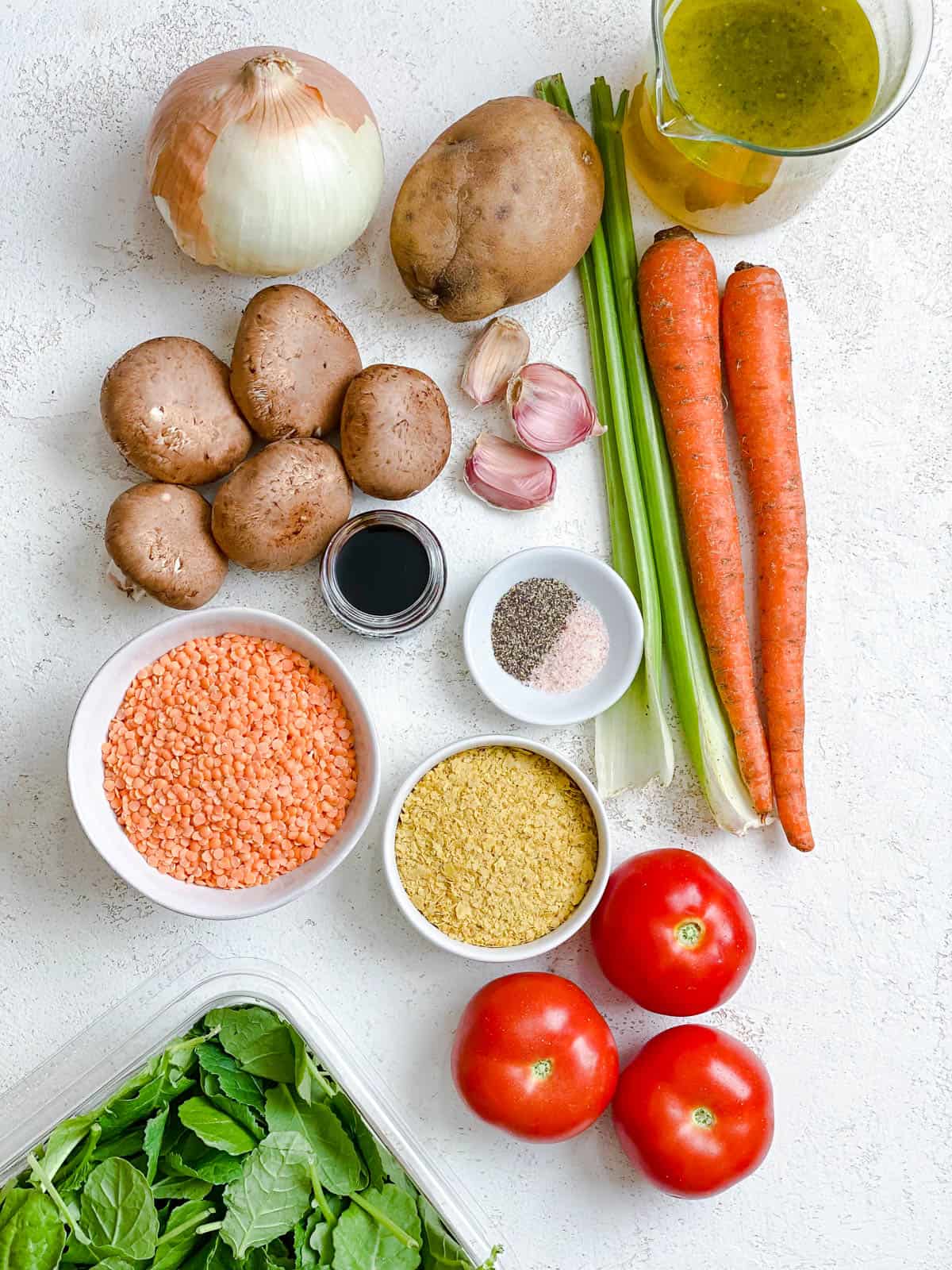 ingredients for Hearty Red Lentil Stew measured out against a white surface