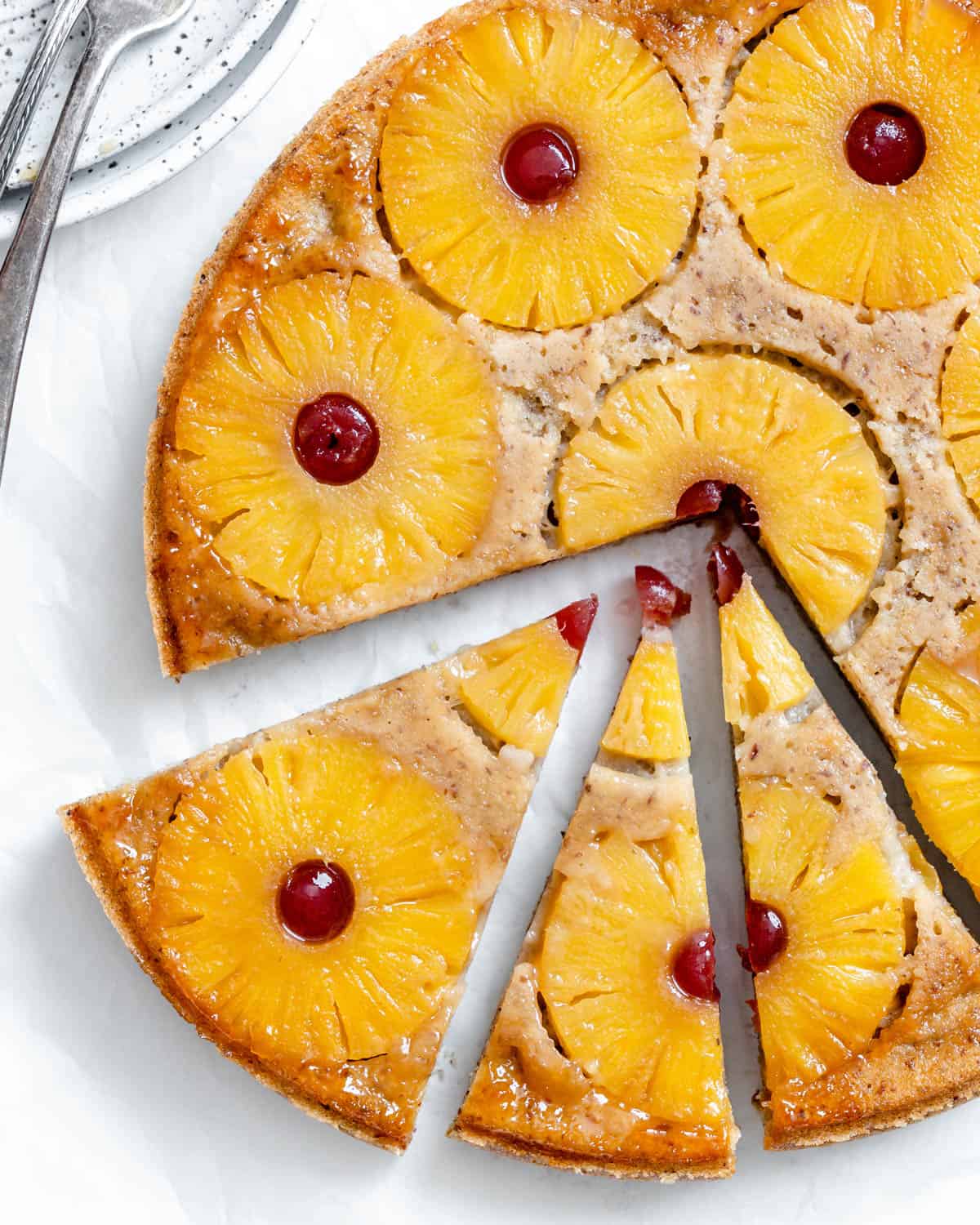 fertiger veganer Ananas-Upside-Down-Kuchen, geschnitten gegen eine helle Oberfläche