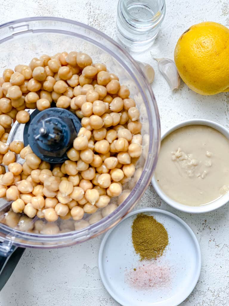 ingredients for Easy Hummus measured out against a white background