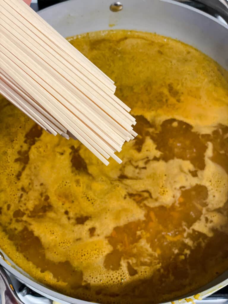 process shot of adding noodles to pan