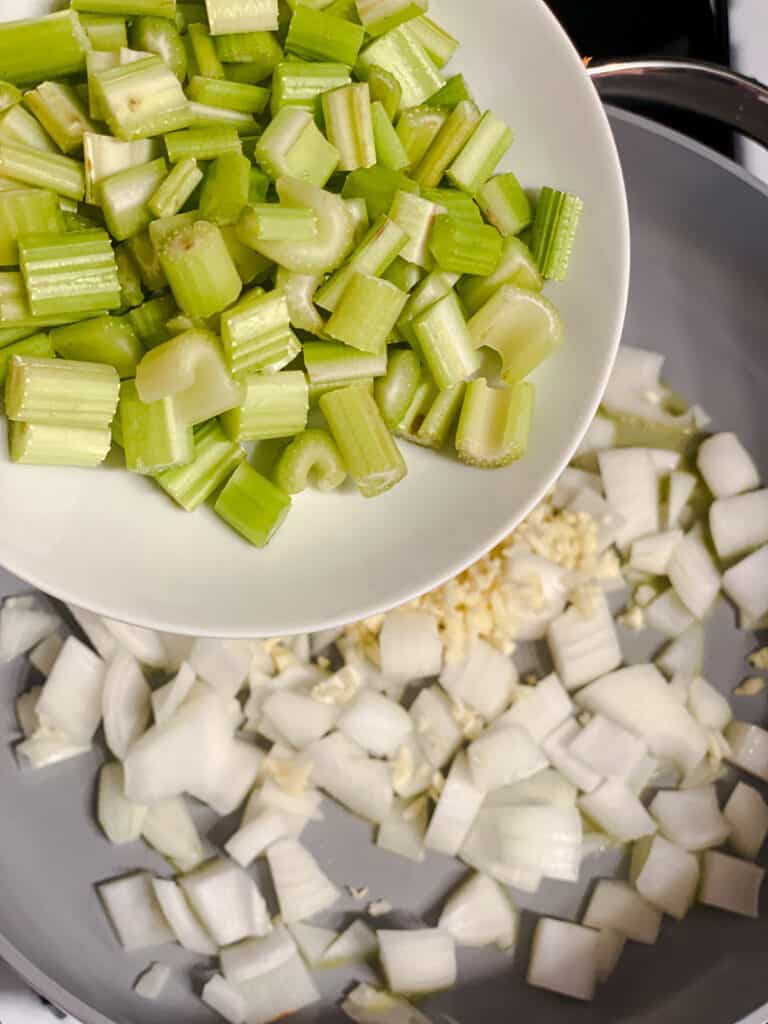 process shot of adding celery to pan
