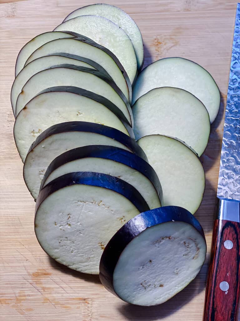 sliced eggplant against a cutting board