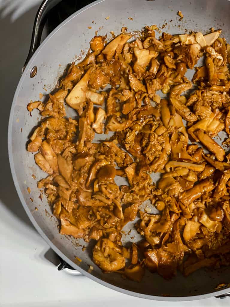 process shot of searing mushrooms in pan