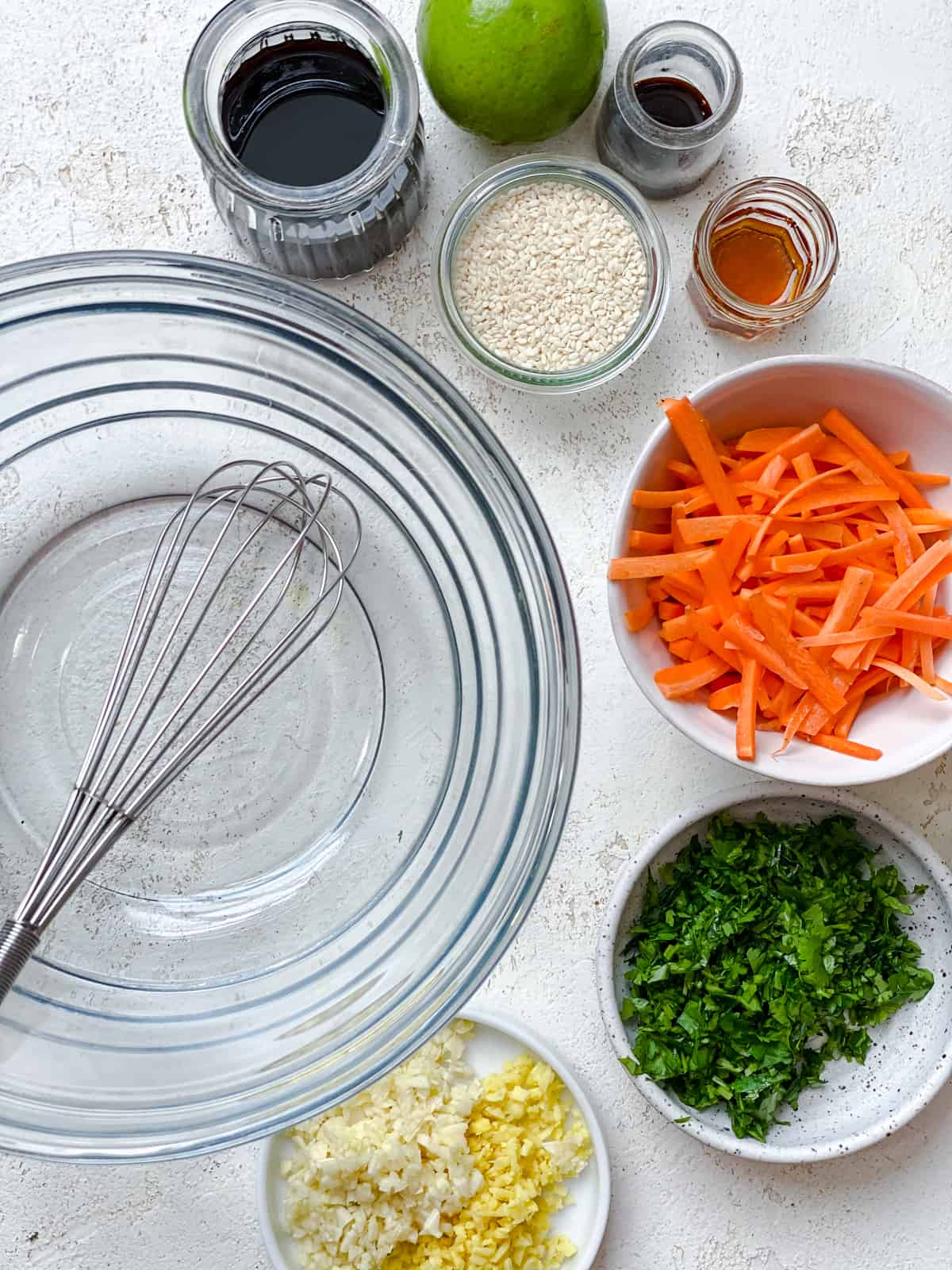 ingredients for Asian Noodle Salad [Cold Sesame Noodles] measured out against a white background alongside a glass mixing bowl