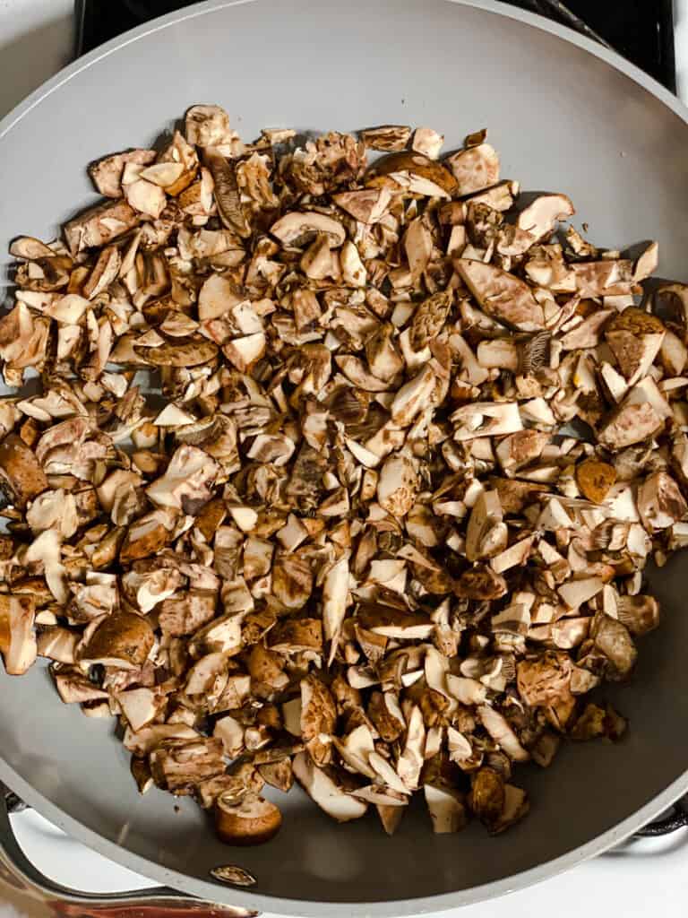 process shot of mushrooms cooking in a pan