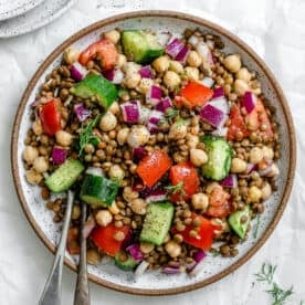completed Mediterranean Chickpea Salad [With Lentils] plated against a white background