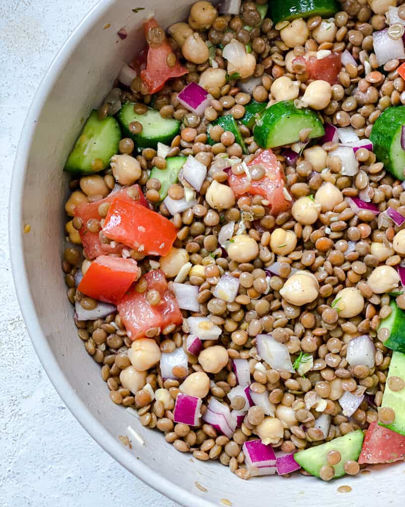 completed Mediterranean Chickpea Salad [With Lentils] plated against a white background