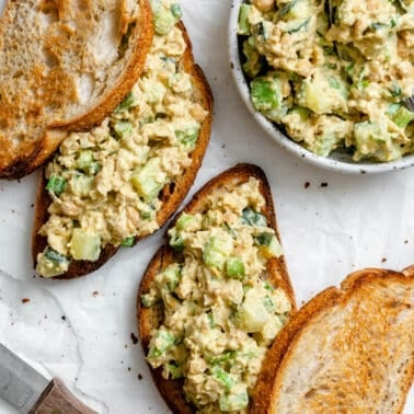 completed Plant-Based Chickpea Tuna Salad on bread against a white surface