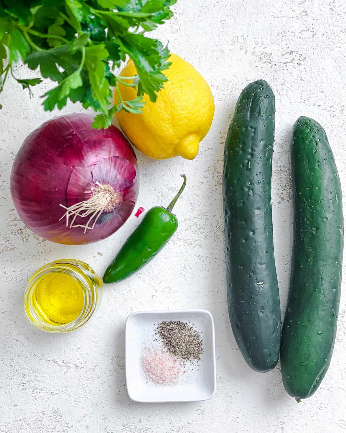 ingredients for Cucumber Salsa [Cucumber Pico de Gallo] measured out against a white surface
