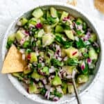 completed ingredients for Cucumber Salsa [Cucumber Pico de Gallo] added to bowl in a bowl against a white background