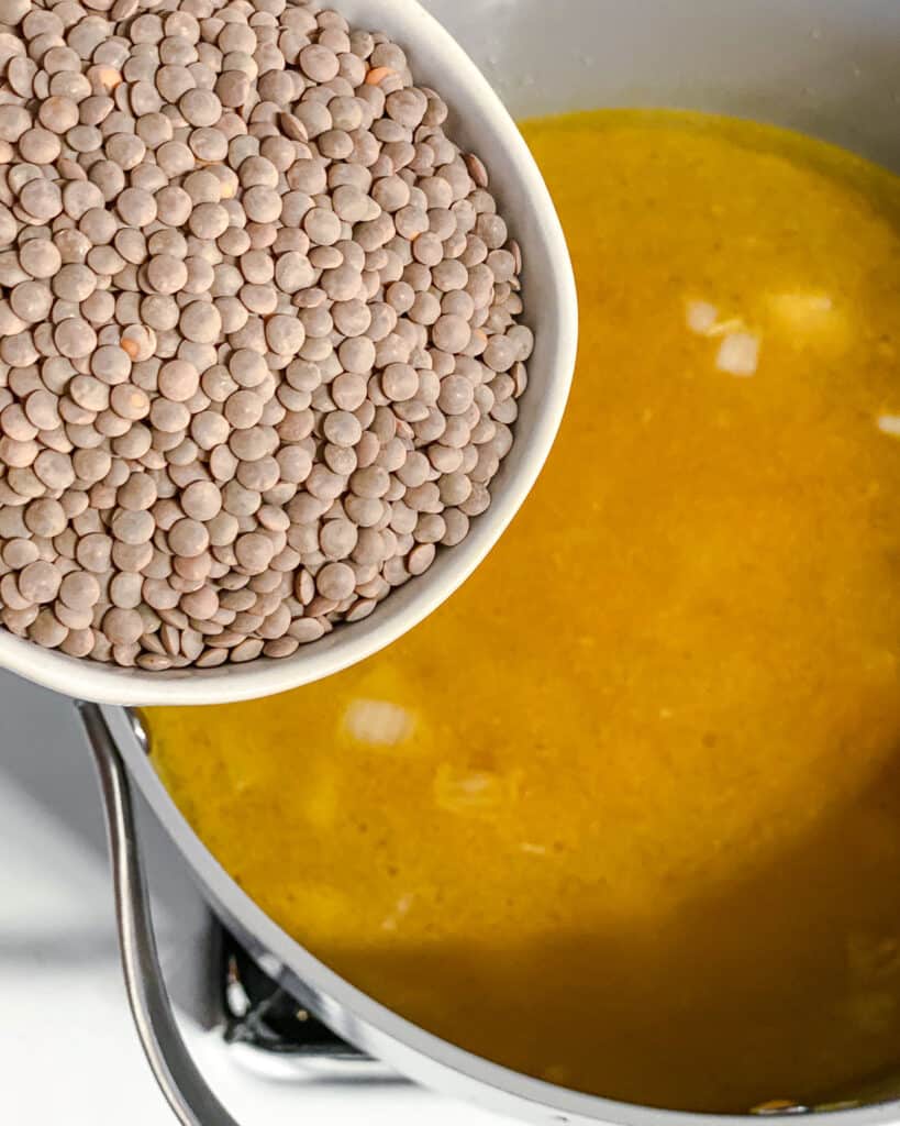 process shot of lentils being added to pot