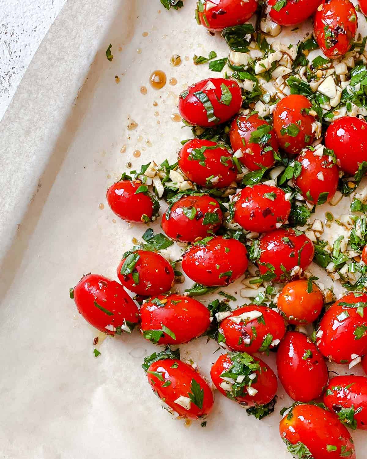 process shot of adding Easy Roasted Cherry Tomatoes to baking sheet