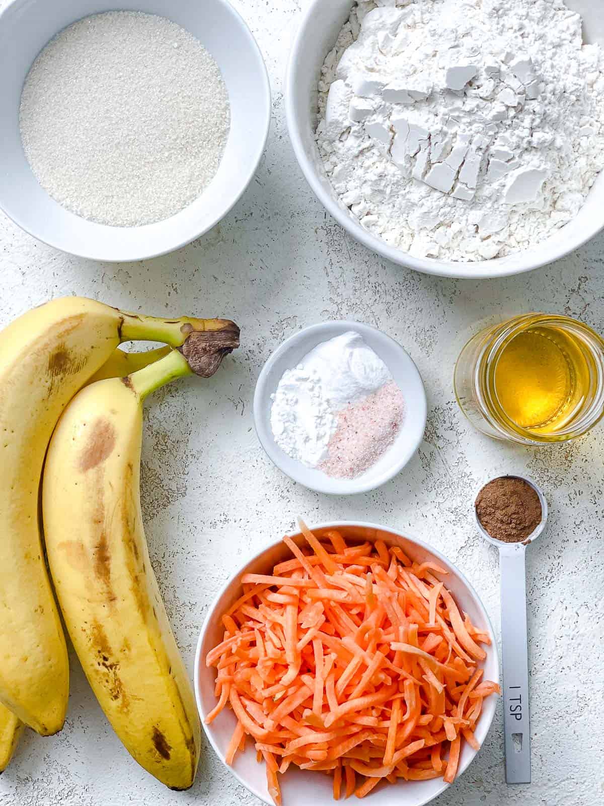ingredients for Carrot Cake Muffins measured out against a white surface