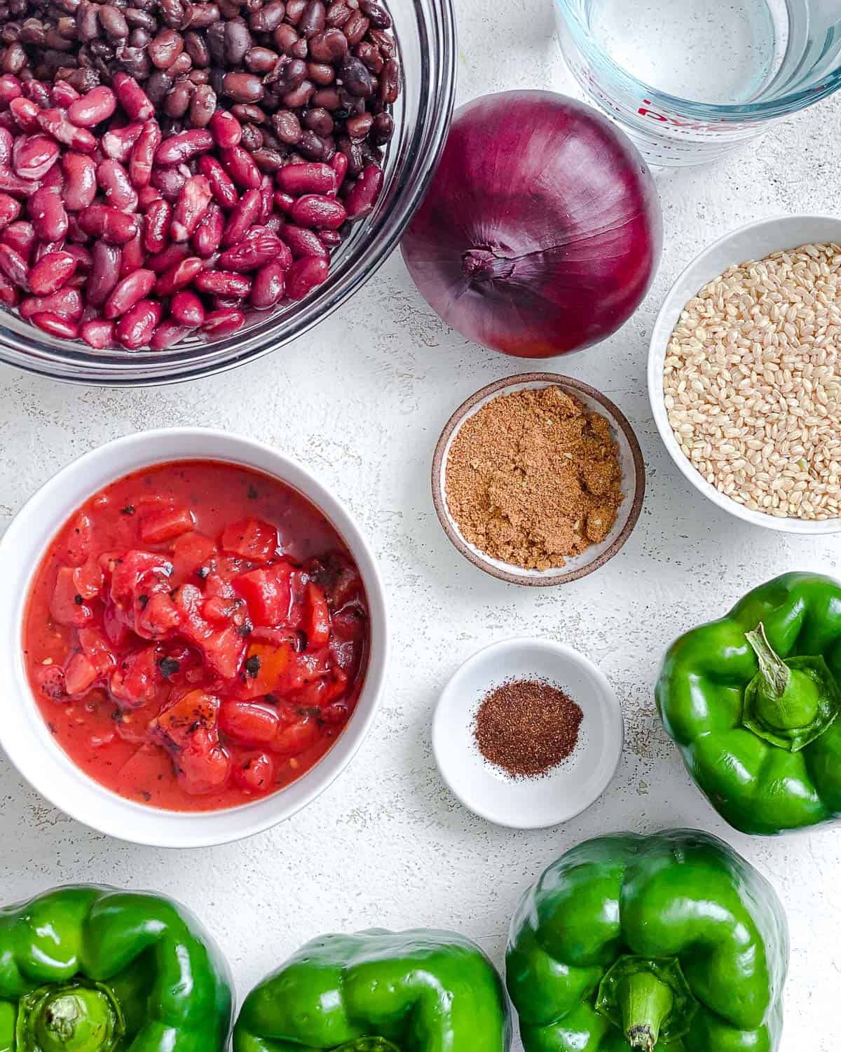 ingredients for Southwest Vegan Stuffed Peppers measured out against a white surface