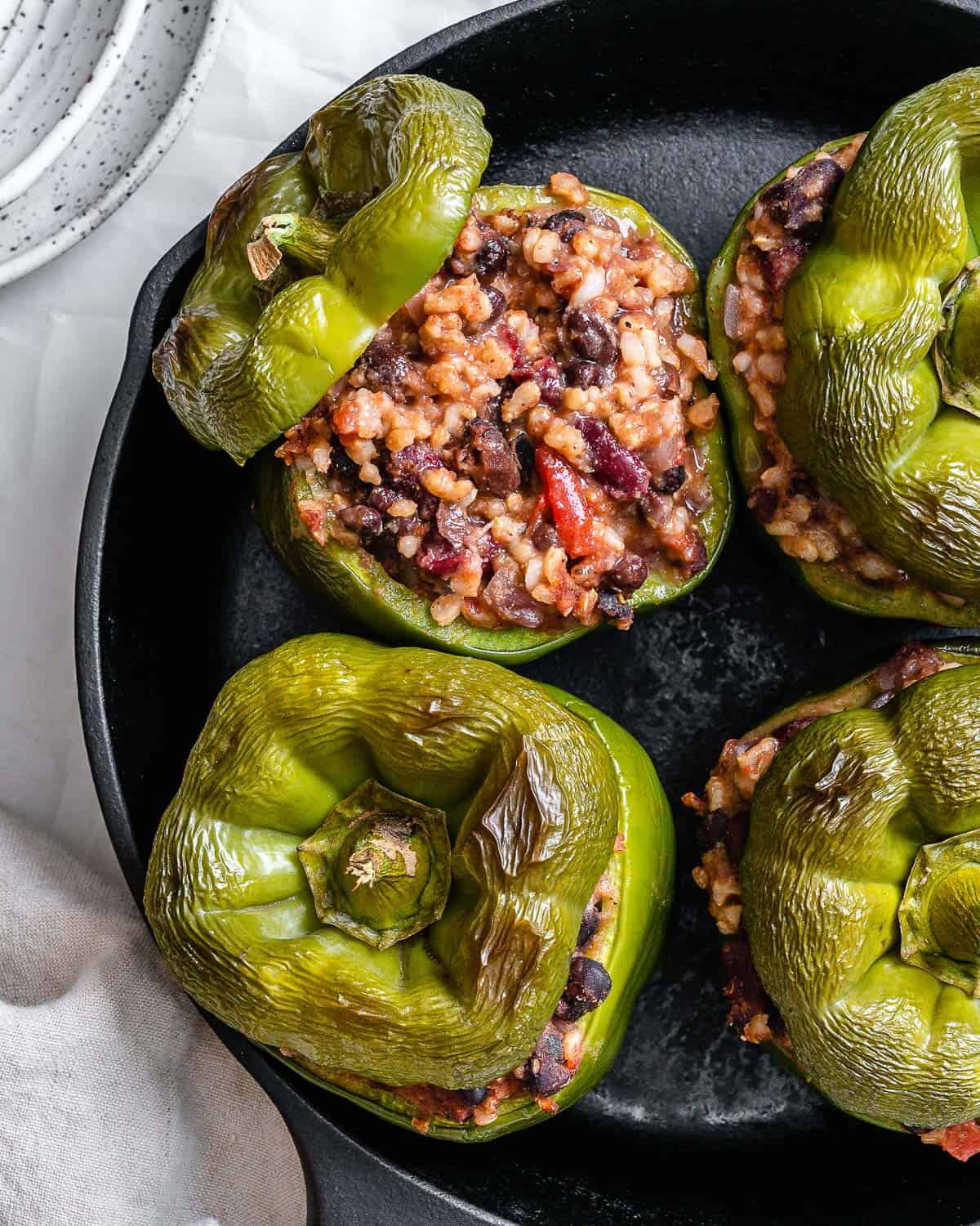 several completed stuffed bell peppers on pan