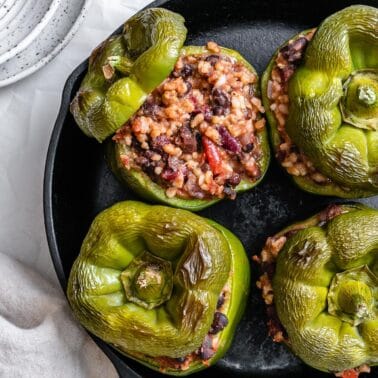 several completed stuffed bell peppers on pan