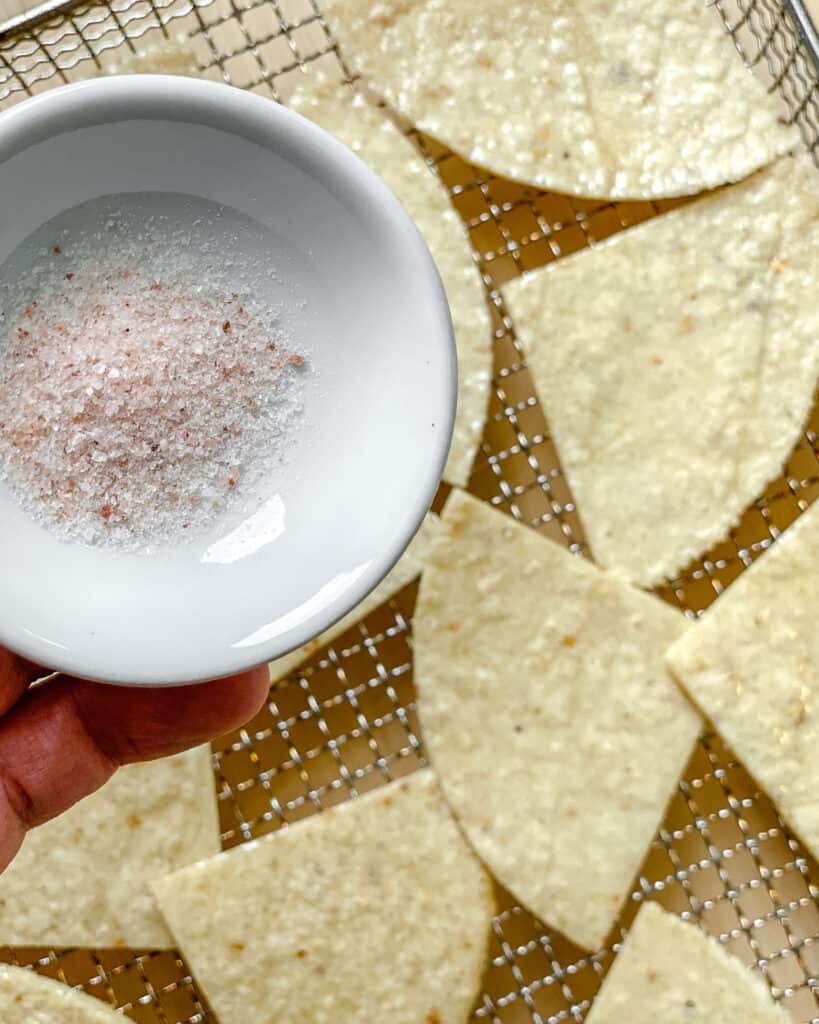bowl of salt alongside tortilla chips