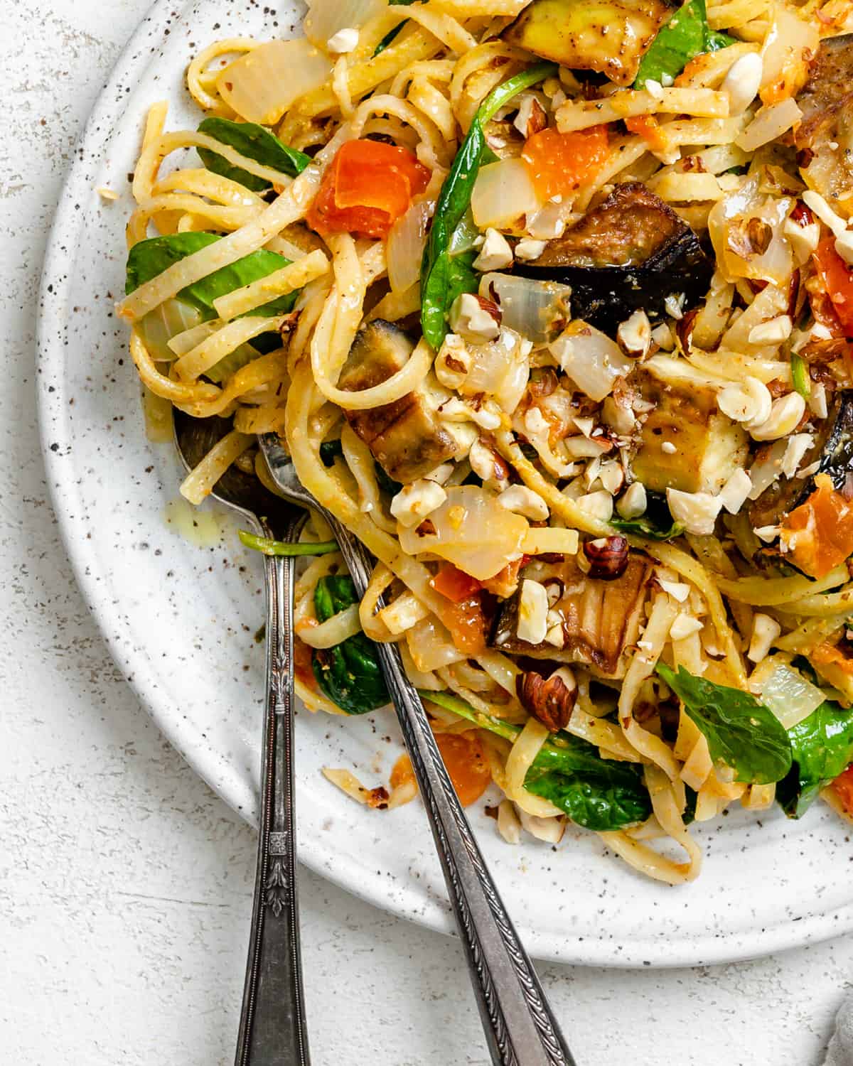 completed Eggplant Pasta with Crispy Hazelnuts [Vegan] on a white plate