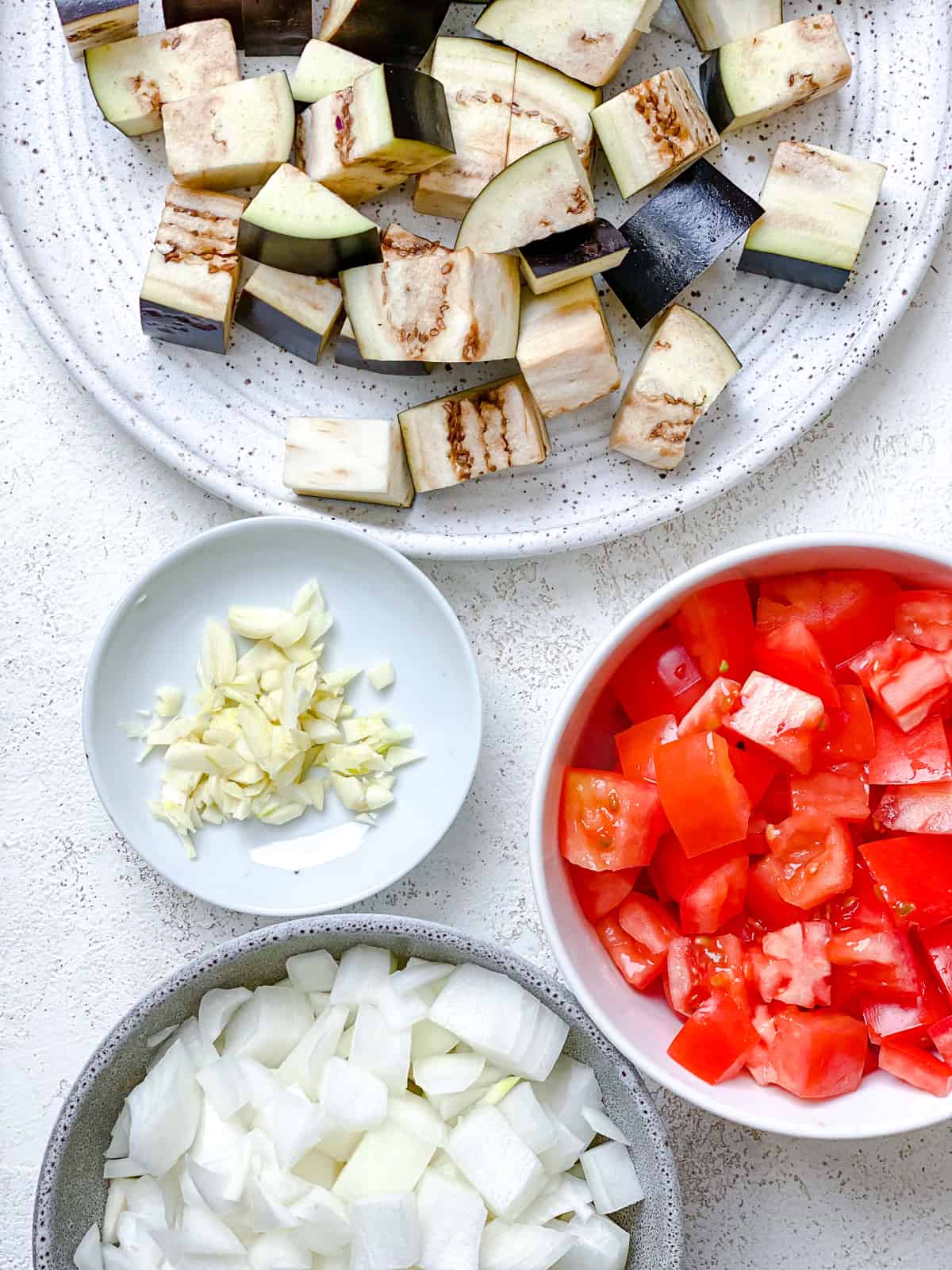 ingredients for Eggplant Pasta with Crispy Hazelnuts [Vegan] measured out against a white surface