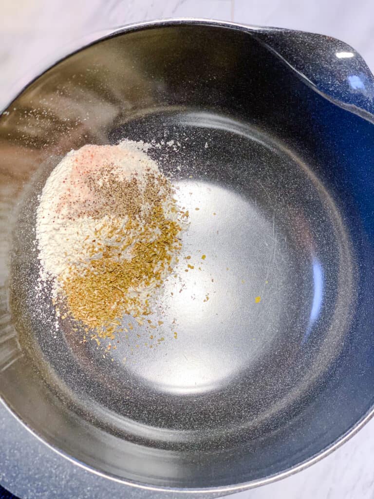 spices added to stainless steel bowl