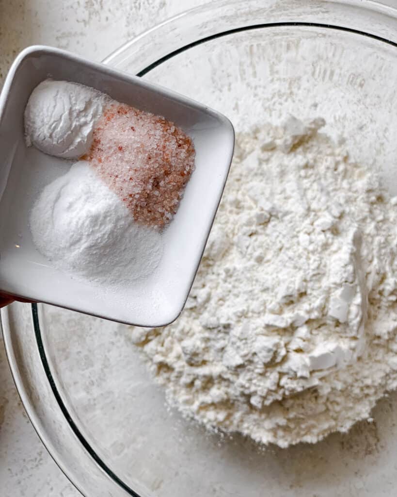 process shot of adding ingredients to flour