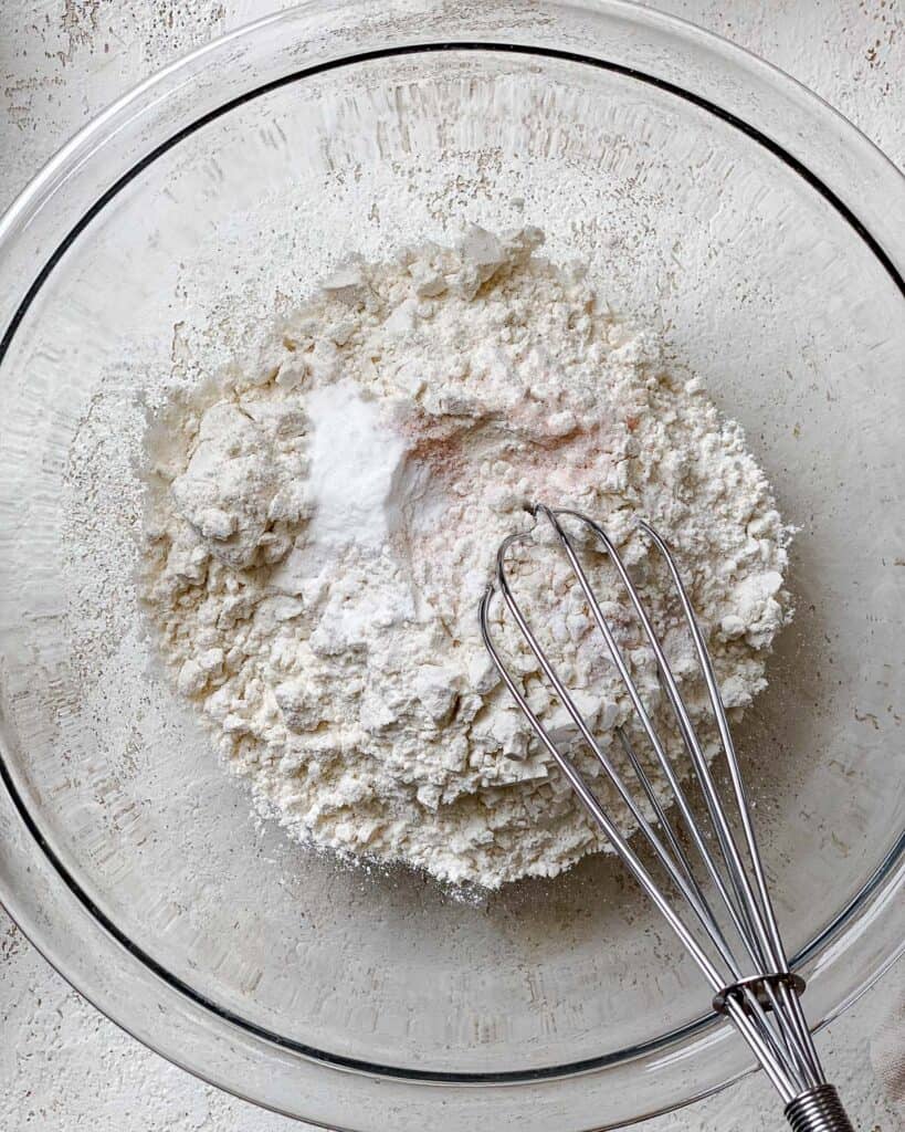 process shot of mixing dry ingredients together with a whisk