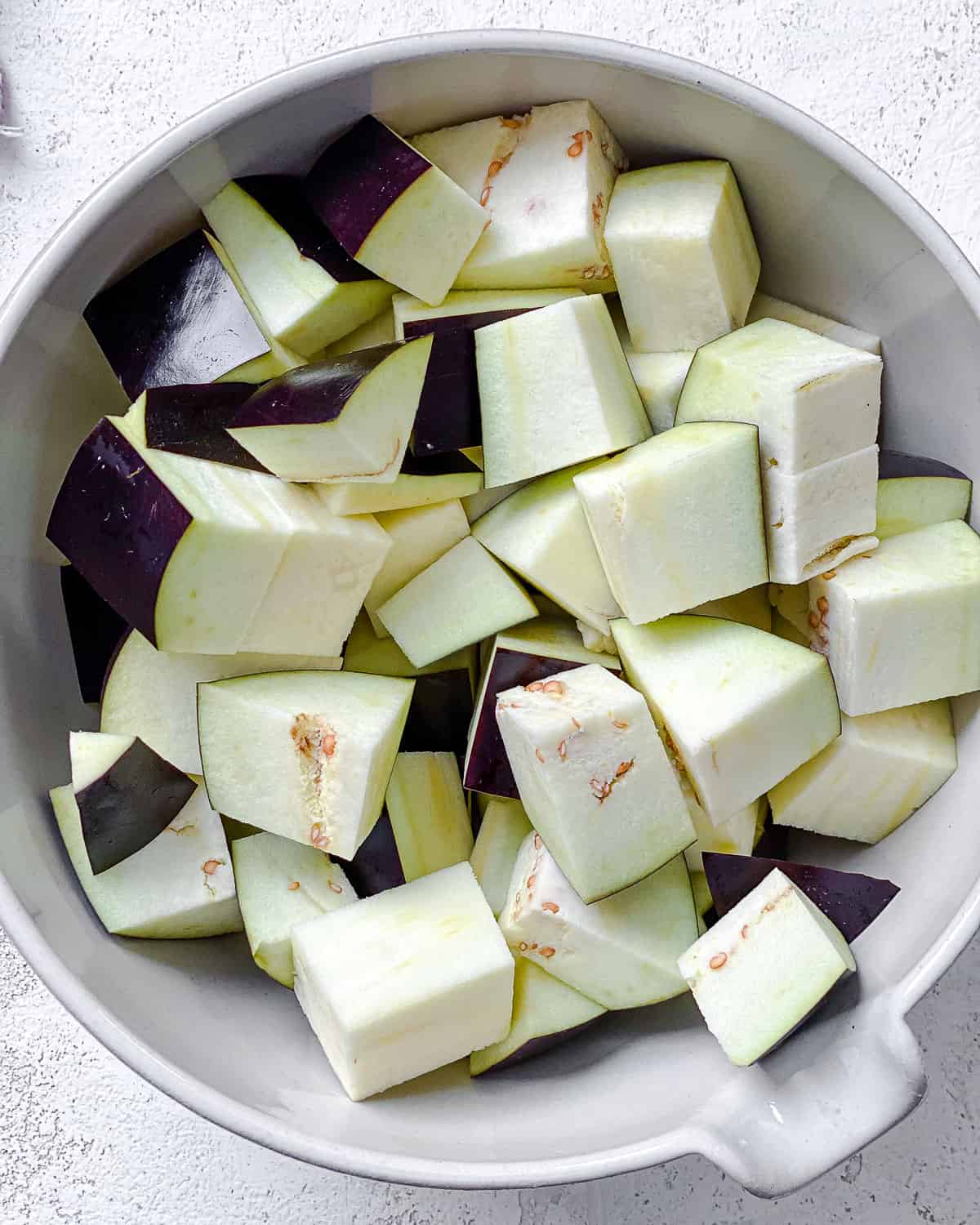 chopped eggplant in a white bowl