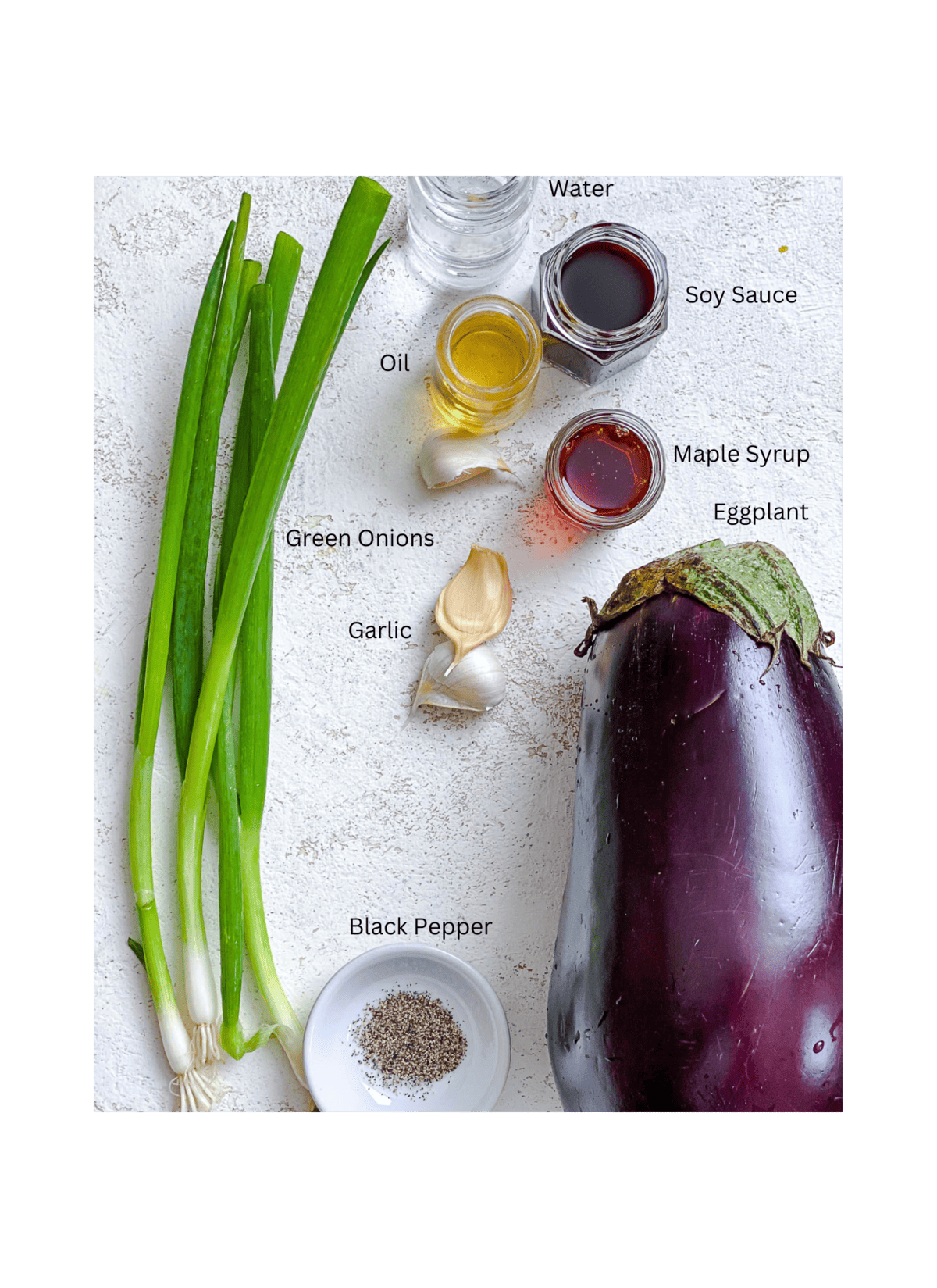 ingredients for Sauteed Eggplant measured out against a white surface