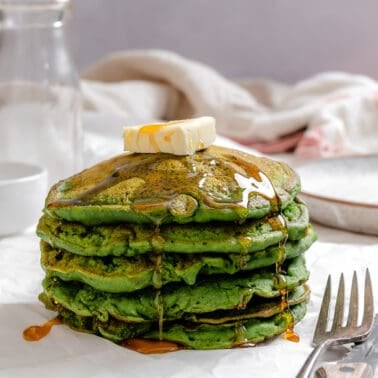 completed stack of Easy Banana Spinach Pancakes against a light surface