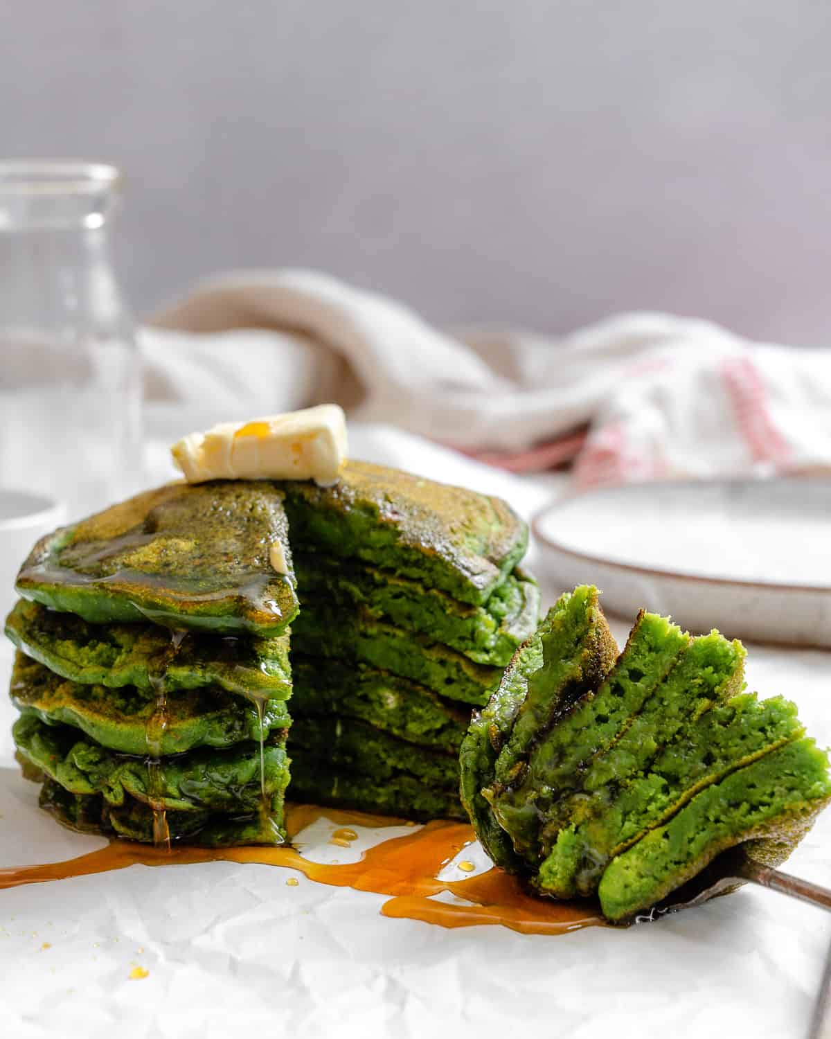 completed stack of Easy Banana Spinach Pancakes against a light surface