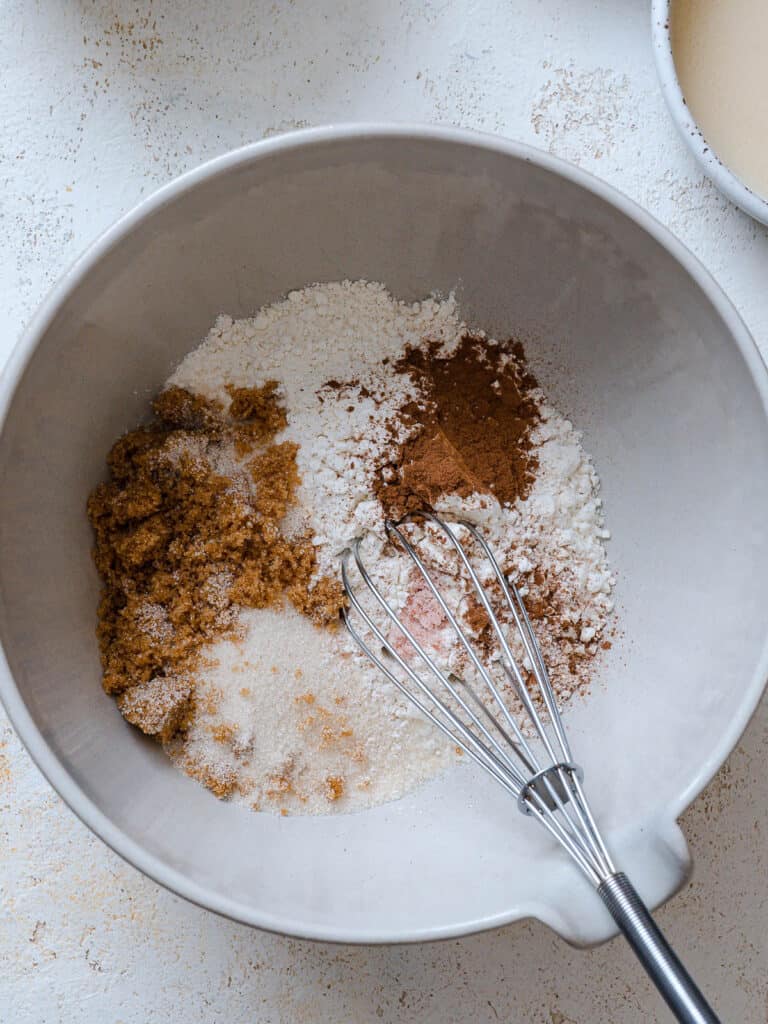 process shot of mixing ingredients together in a bowl with a whisk