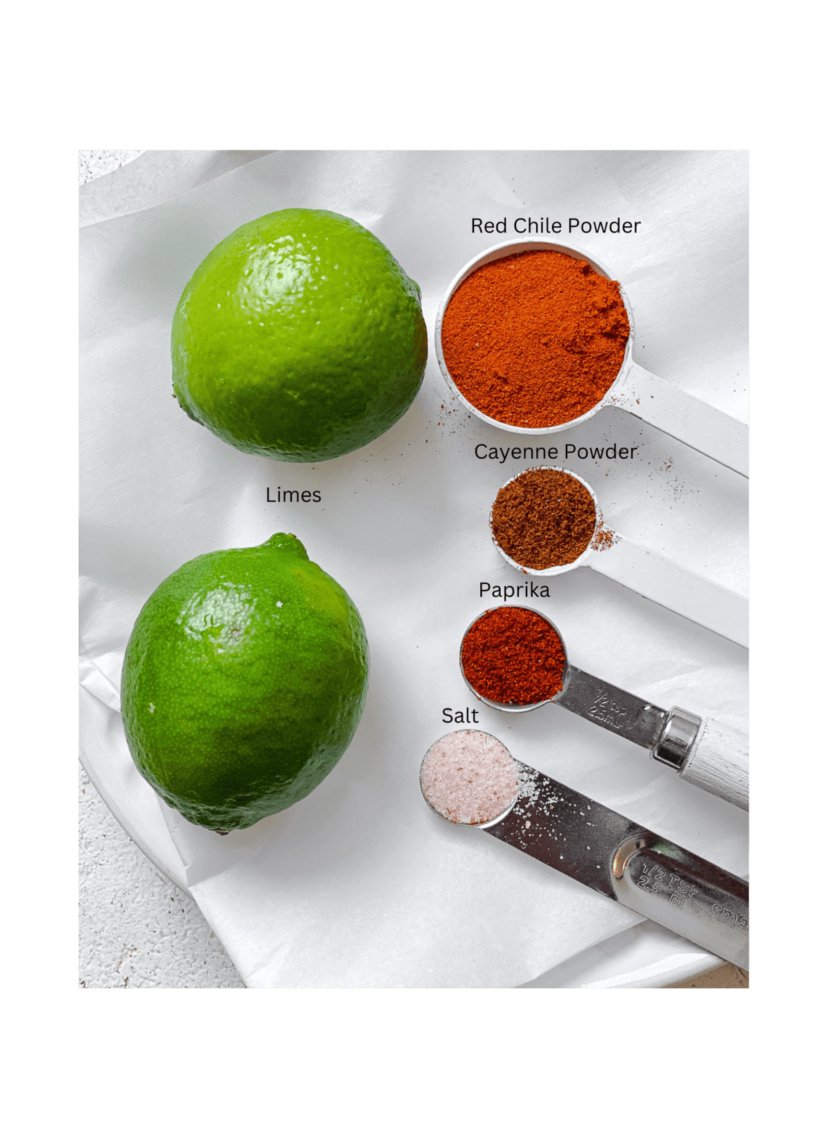 ingredients for Homemade Chili Lime Seasoning (Tajin) measured out against a white surface