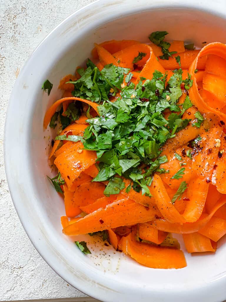 post process of adding dressing to carrot salad