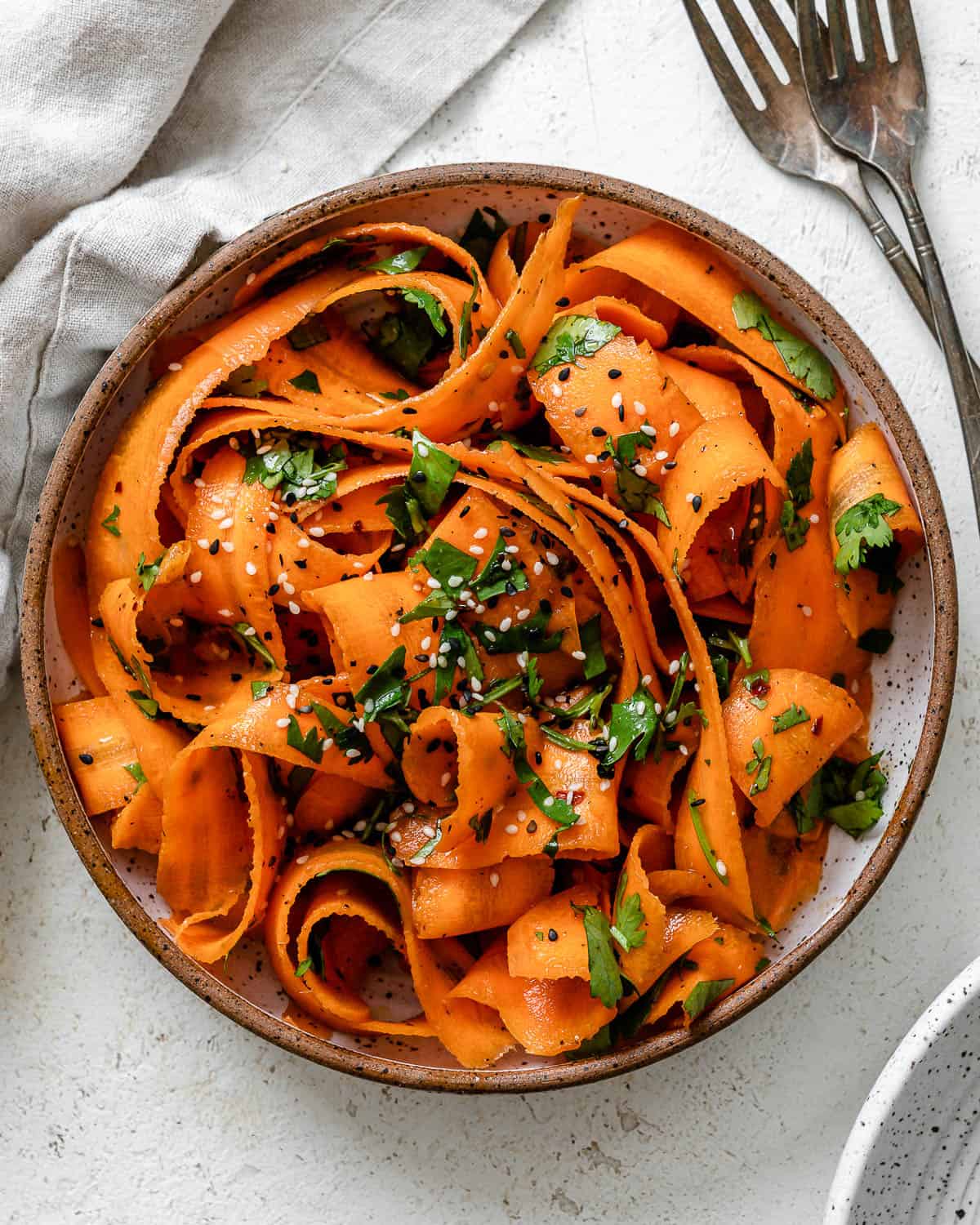 completed Raw Carrot Salad plated against a white background