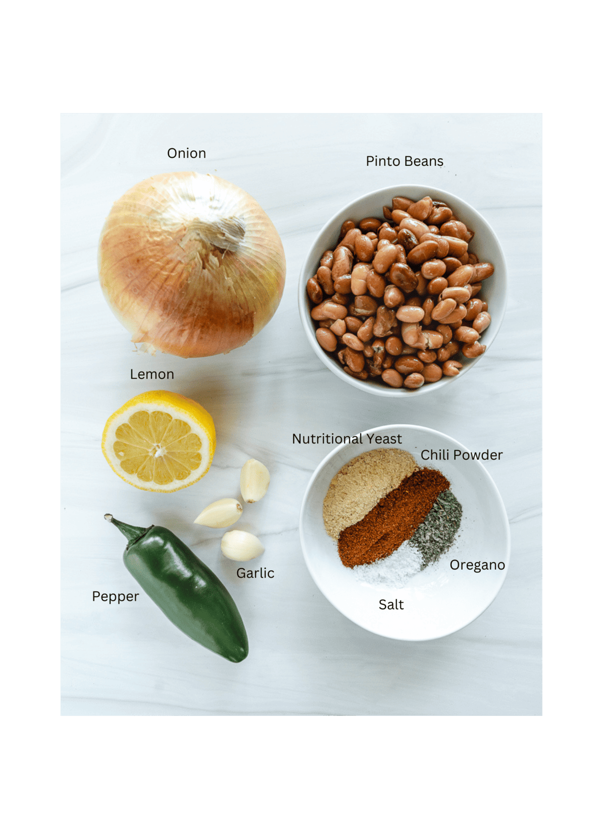 ingredients for Spiced Refried Bean Dip measured out against a white surface