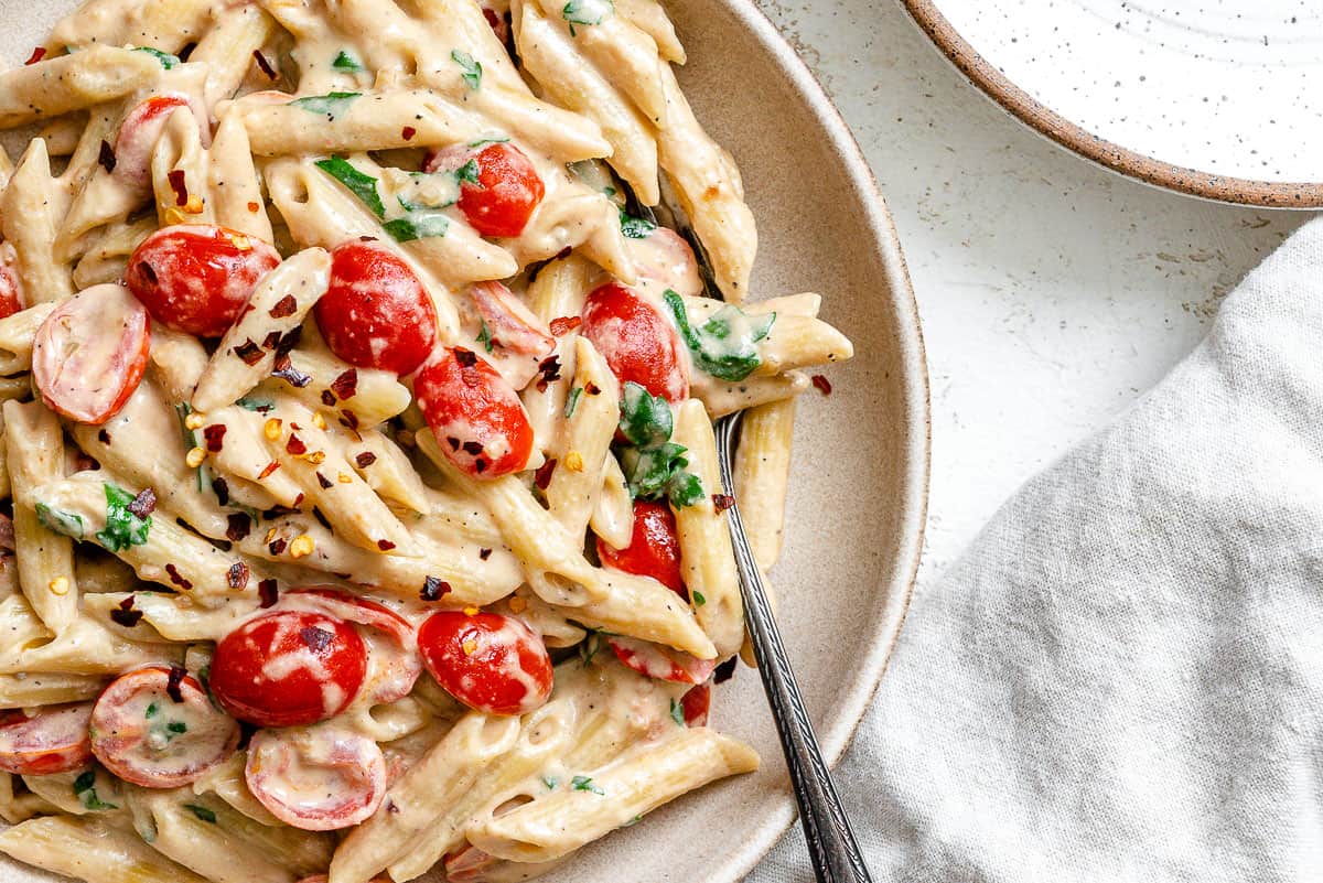 completed 20-Minute Creamy Tahini Pasta plated on a white plate against a light surface