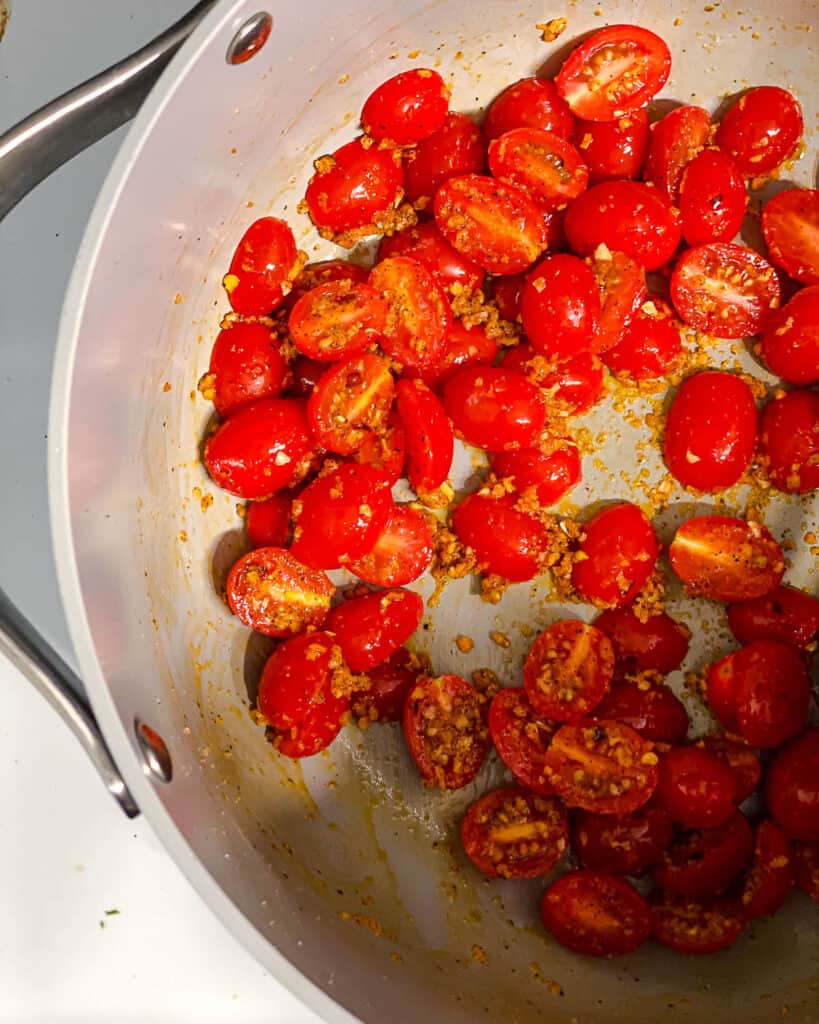 process shot of tomatoes cooking in pan
