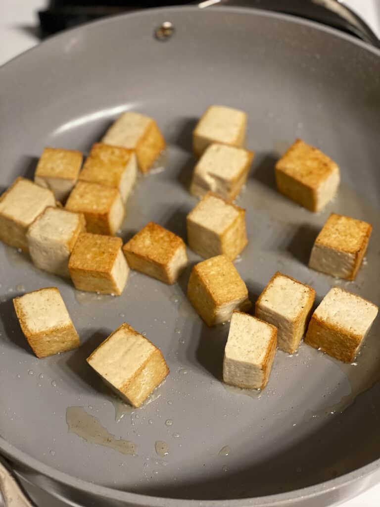 process shot of tofu cooking in pan