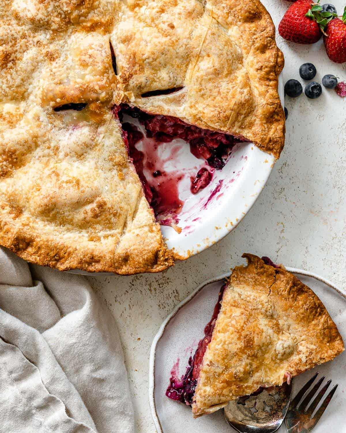 completed Blueberry Strawberry Pie with a slice plated on the side