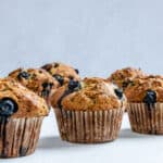 post cooked Blueberry Zucchini Muffins against a white background